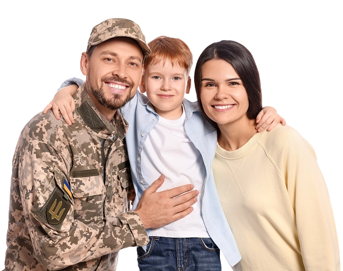 Smiling family with soldier in camouflage uniform.