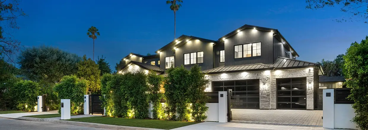 Modern house exterior with night lighting.
